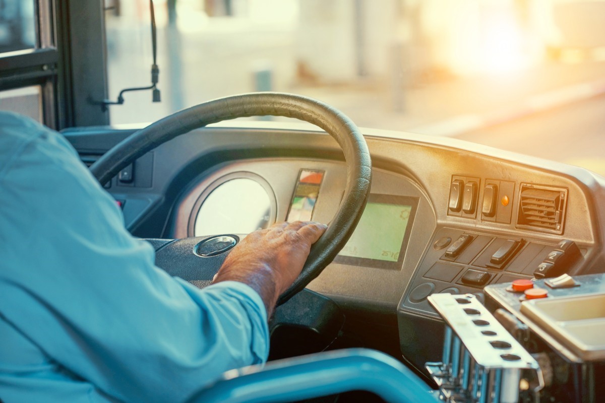 truck bus driving with hands on steering wheel